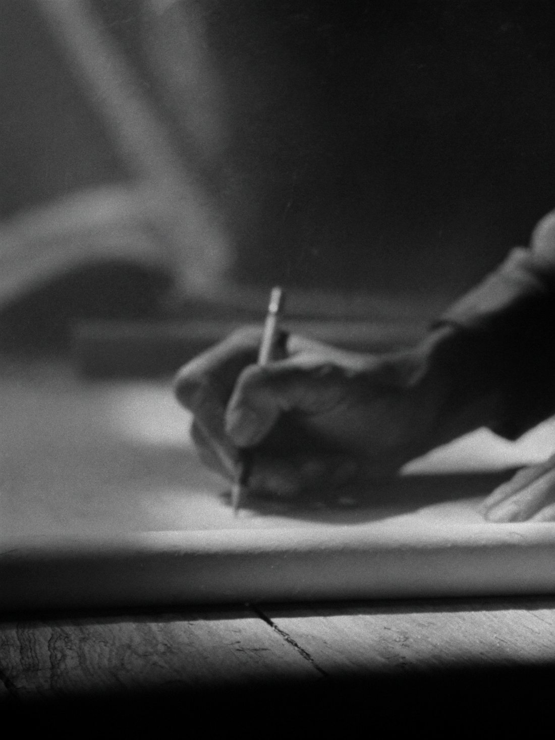 Working hands drafting over plans